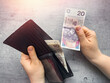 Woman put or check polish zloty cash in the wallet. Money saving concept.