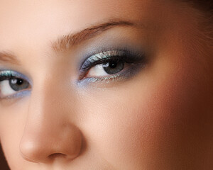 Closeup of eye make up on model with silver purple glossy eyes