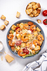 Wall Mural - Shrimp Caesar Salad in a Bowl with Parmesan Cheese, Dressing and Croutons