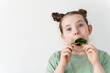 Crazy little girl stuffing spinach leaves into her mouth. Fun, wholesome food.