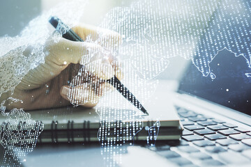 Poster - Double exposure of abstract digital world map and hand writing in notebook on background with laptop, research and strategy concept