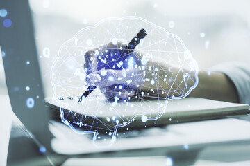 Poster - Double exposure of creative artificial Intelligence symbol with hand writing in notebook on background with laptop. Neural networks and machine learning concept