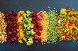 Preparing fresh vegetables in summer for winter, various frozen vegetables and berries on a dark blue background, top view