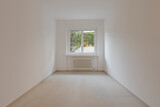 Fototapeta Zwierzęta - Empty interior of a room, with a central window in the background.