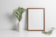 Vertical wooden frame mockup with eucalyptus plant, blank mockup with copy space
