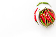 Fresh red and green chilli pepper pattern on white table background top view mockup