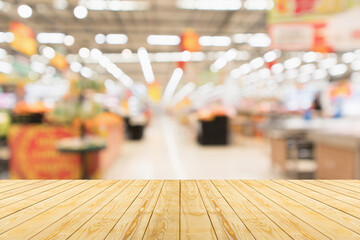 Canvas Print - Empty wood table top with supermarket blurred background for product display