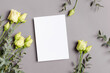 Blank invitation or greeting card mockup with fresh flowers, mockup with copy space