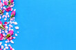 Design with pebble and flowers frame on blue background top view space for text