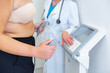 © BGStock72 - Obese young woman undergoes a body composition analysis with a professional health expert