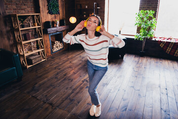 Sticker - Full size photo of young woman dancing listen music headphones kiss wink wear striped outfit interior home living room in brown warm color