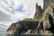 Trøllkonufingur -  imposing rock pillar rising from the sea at the coast of Vágar on the outskirts of Sandavágur.