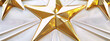 Golden 3D stars on white pleated fabric background, conveying luxury, success and celebration.