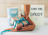 Fototapeta Tulipany - Father's day concept card,gift box ,beverage and tie. Male accessories. Greeting template with message.