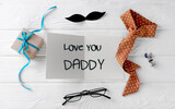 Fototapeta Tulipany - Father's day concept top view card,gift box and tie. Male accessories.