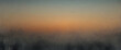 A serene sunrise scene blurred through a misty texture, depicting tranquility and the break of day