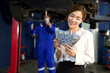 businesswoman or customer holding and counting cashes pay for technician in automobile repair shop