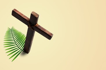 Wall Mural - Wooden cross and palm leaf on background