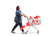 Full length profile shot of a corpulent woman pushing a shopping cart with hearts
