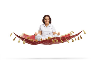 Poster - Elderly woman meditating on a floating magic carpet