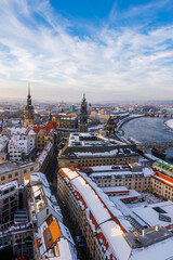 Wall Mural - The Dresden and Elbe river cityscape covered in snow on a cold winter day in late afternoon.