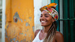 Happy young Afro-Brazilian woman smiling, wearing colorful turban in Pelourinho, the Historic Center of Salvador, Bahia, Brazil.
