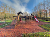 Fototapeta Na ścianę - Colorful playground with climbing stairs and slides on yard in the park. 