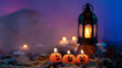 Halloween background, 3 pumpkin-shaped candles in the foreground, an old lamp on a rock against a blue out-of-focus background