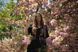 © David - Portrait of a Woman Surrounded by Ornamental Cherry Blossoms and Lush Foliage