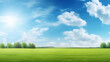 © cabado - Beautiful spring summer natural landscape. Green meadow grass and trees on blue sky background with sun and clouds on warm sunny day. Colorful bright nature wallpaper with copy space for text.