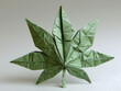 A green origami cannabis leaf standing on a white background, demonstrating intricate folding techniques.