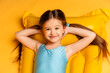 © Irina Mikhailichenko - Close up top view little girl in blue swimsuit, resting on yellow inflatable mattress for swimming on yellow background. Summer vacation, travel, resort. Summer sea rest concept. high quality photo