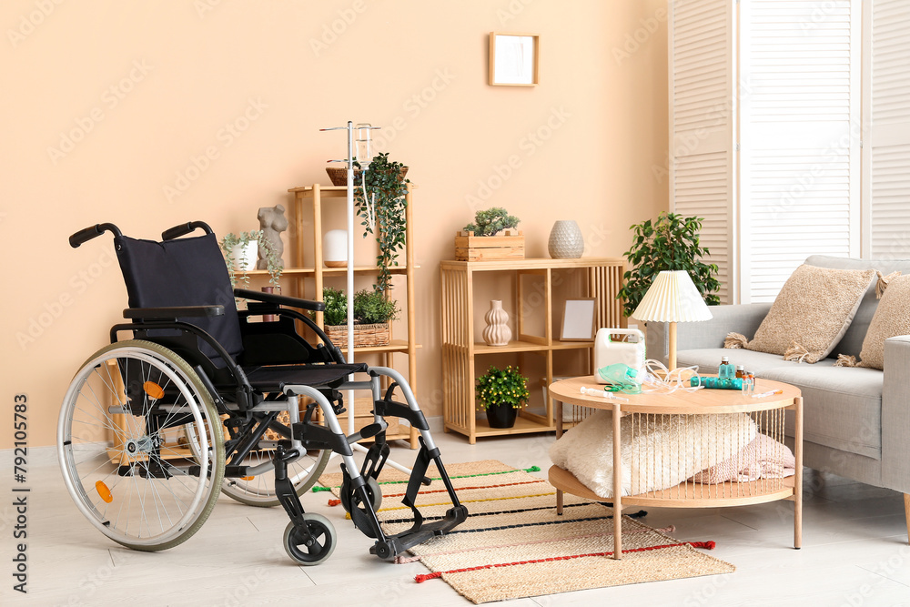 Modern empty wheelchair in living room near beige wall