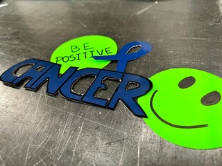 A sticker with a smiling face and the word 