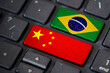 China and Brazil flags on computer keyboard