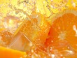 Extreme close-up of orange juice with ice cubes and sliced oranges. Splashes of orange juice on an orange background with drops of sparkling water.