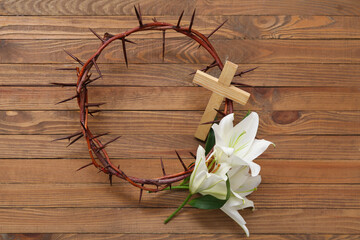 Wall Mural - Crown of thorns with white lilies and cross on wooden background