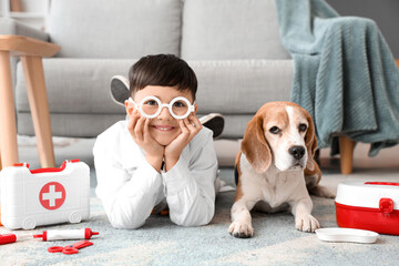 Poster - Cute little doctor with Beagle dog lying on floor at home