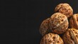 Group of walnuts with textured shells against dark background
