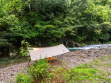 Fototapeta Miasto - Canopy of camping by the stream