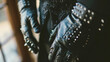 The grooms black leather gloves decorated with small silver spikes and intricate stitching adding a touch of edginess to his wedding attire. .