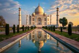 Fototapeta Tulipany - Magnificent Taj Mahal Bathed in Golden Sunset Reflected in Serene Pool