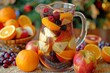 Sangria pitcher with orange, apple and berry slices