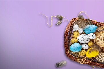 Wall Mural - Colorful fresh Easter eggs in basket on colored background