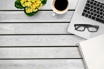 Wall Mural - Wooden desk with laptop, notebook and cup of coffee