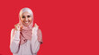 Winner yes. Victory joy. Positive reaction. Pleased satisfied excited cheerful happy woman in headscarf isolated on red empty space background.