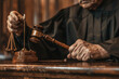 Close up of a lawyers hands holding a gavel in a courtroom