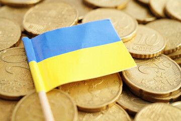 Wall Mural - Ukraine flag on coin and banknote money, finance trading investment business currency concept.