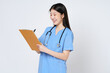 Smiling young woman doctor taking notes making medical with clipboard isolate over white background.