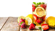 A glass of lemonade and strawberries on a wooden table isolated on a transparent background